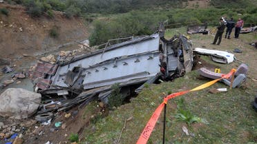 Tunisian security forces check the debris of a bus that plunged over a cliff into a ravine, in Ain Snoussi in northern Tunisia on December 1, 2019. (AFP)
