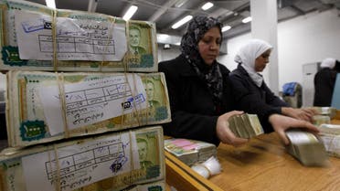 This January 13, 2010 file photo, employees stack Syrian currency in the Central Bank, in Damascus, Syria. (AP)