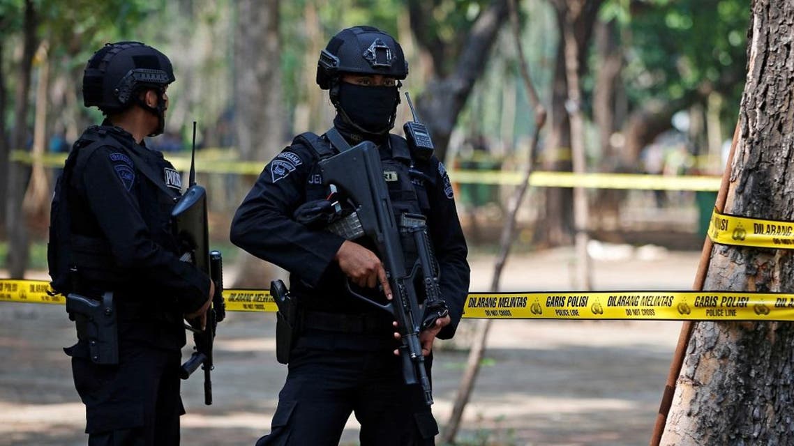 Armed police officers stand guard following a blast at National Monument (Monas) complex in Jakarta.