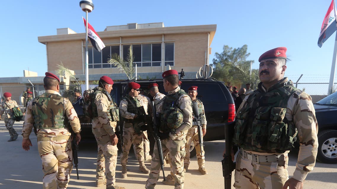 Iraqi army soldiers stand before a conference on fighting the Islamic State group attended by Iraq's tribal leaders, militiamen and members of the government, at the Al-Asad air base, in Iraq's mainly Sunni Anbar province, on November 11, 2014. A team of US troops was on the ground in Iraq's Anbar province today as Washington steps up efforts to help Iraqi forces battle the Islamic State jihadist group. Parliament speaker Salim al-Juburi visited tribal leaders from Anbar at Al-Asad base to raise morale and urge the government to (provide) a large amount of... weapons and equipment to face the danger of terrorism, he told AFP. AFP PHOTO/AHMAD AL-RUBAYE