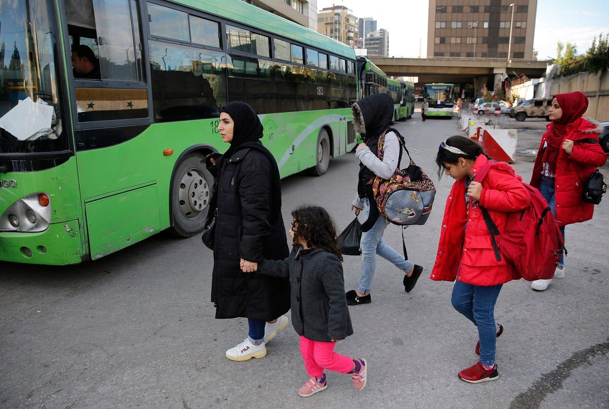 Syrian refugees prepare to board a bus to take them home to Syria, in Beirut, Lebanon, Tuesday, December 3, 2019. (AP)