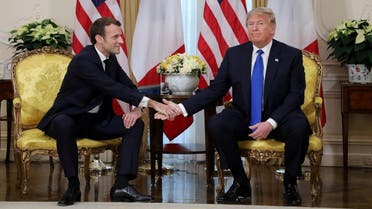 US President Donald Trump and France's President Emmanuel Macron shake hands during their meeting at Winfield House, London on December 3, 2019. (AFP)