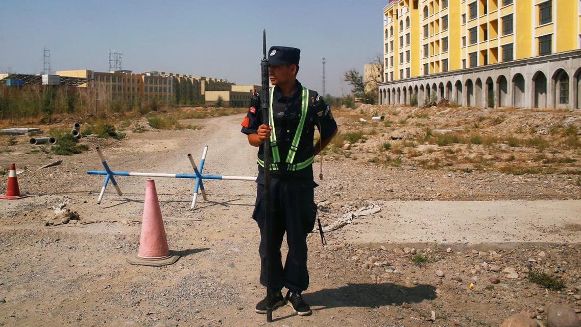 A Chinese police officer takes his position by the road near what is officially called a vocational education center in Yining in Xinjiang Uighur Autonomous Region, China (File photo: Reuters)