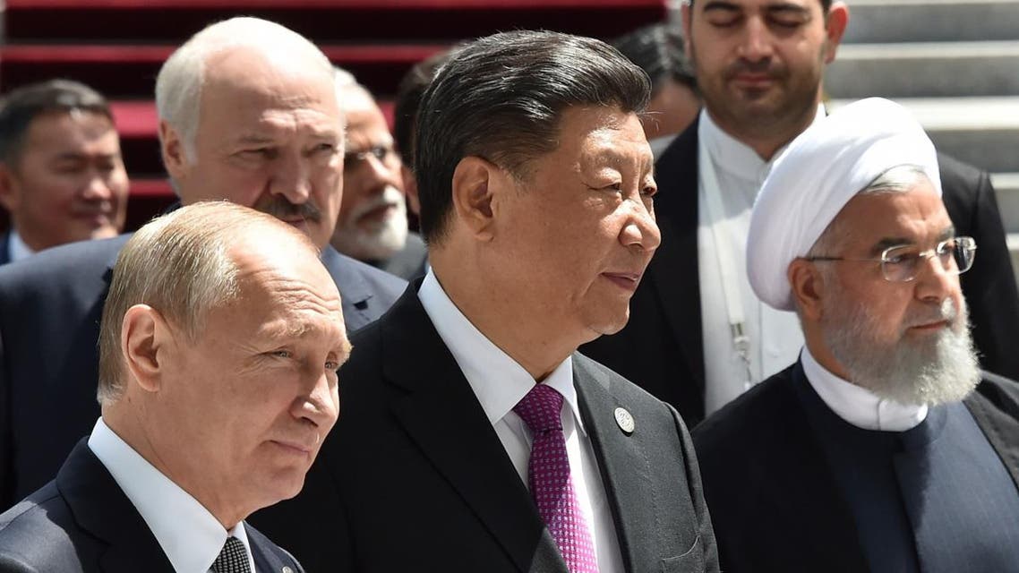 Russian President Vladimir Putin, Chinese President Xi Jinping and Iran's President Hassan Rouhani walk as they attend a meeting of the Shanghai Cooperation Organisation (SCO) Council of Heads of State in Bishkek on June 14, 2019. (AFP)
