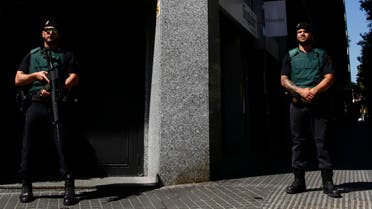 Spanish Guardia Civil members stand during an operation in Barcelona, Spain, Wednesday, July, 5, 2017. Spanish police have arrested 14 people in the northeastern city of Barcelona as part of a European operation against the Camorra organized crime gang. The State prosecutors' office said there were also arrests in Italy and Germany in the Europol-coordinated operation Wednesday against drug trafficking and money laundering. (AP Photo/Manu Fernandez)