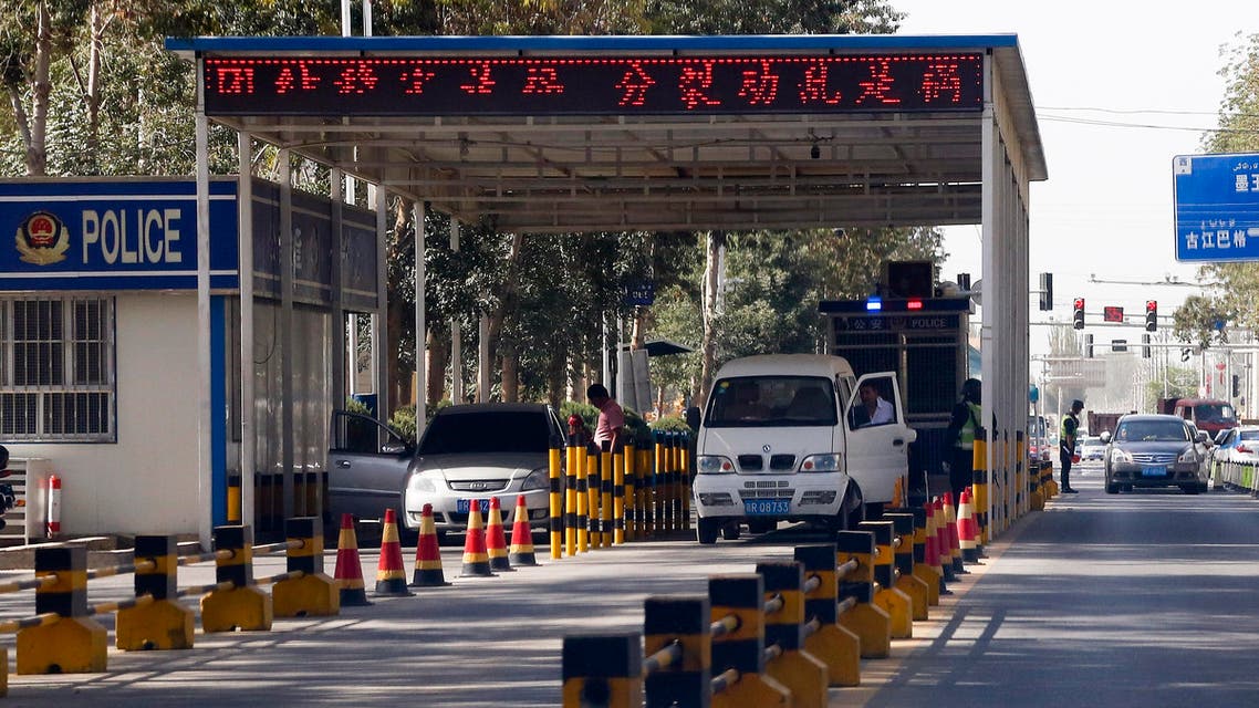 In this Sept. 21, 2018, photo, Uighur drivers have their vehicles checked at a police check point in Hotan, in western China's Xinjiang region. (AP)