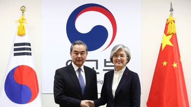 South Korea Foreign Minister Kang Kyung-wha, right, shakes hands with Chinese Foreign Minister Wang Yi during their meeting at foreign ministry on Wednesday, Dec. 4, 2019 in Seoul, South Korea. (AP)