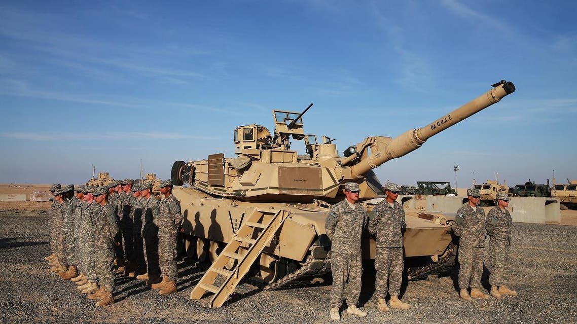 US troops stand at attention next to an Abrams tank at Camp Buehring, Kuwait. (File photo: AFP)