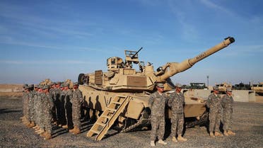 US troops stand at attention next to an Abrams tank at Camp Buehring, Kuwait. (File photo: AFP) 