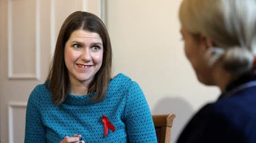 Britain's opposition Liberal Democrats leader Jo Swinson (L) reacts during a general election campaign visit to Bridge House Care Centre in Wallington, south of London. (AFP)