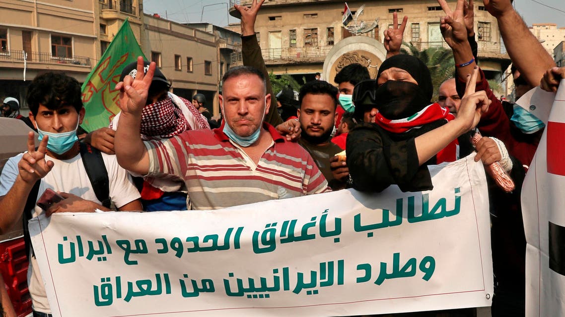 Iraqi Anti-government protesters hold a banner with Arabic that reads, "We demand the expulsion of Iranians from Iraq and the closure of the border with Iran" during ongoing protests in Baghdad, Iraq, Friday, Nov. 29, 2019.(AP)