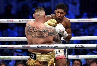British boxer Anthony Joshua (white trunks) competes with Mexican-American boxer Andy Ruiz Jr (golden trunks) during the heavyweight boxing match in Diriya, near the Saudi capital Riyadh, dubbed “Clash on the Dunes.” (AFP)