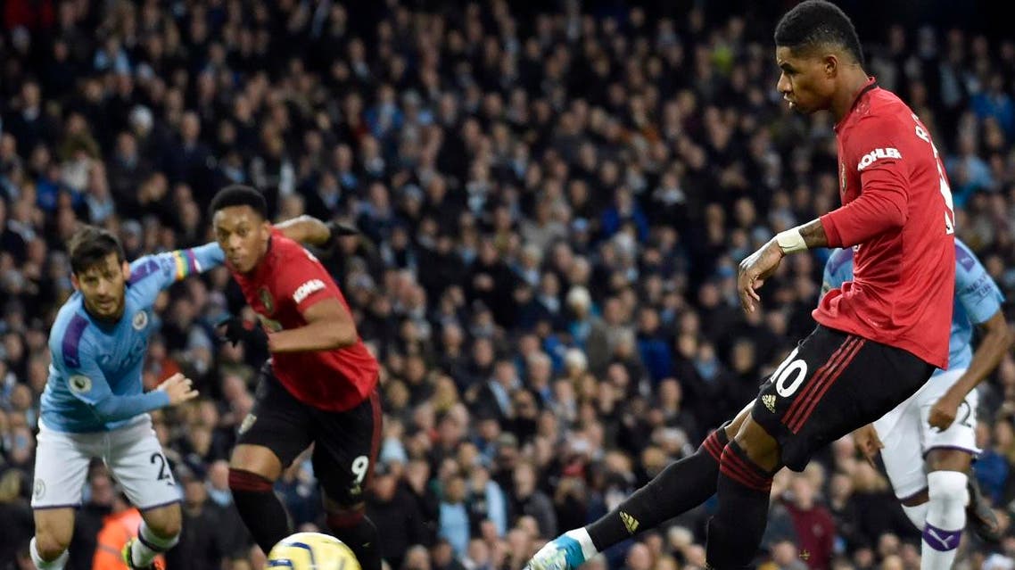 Manchester United’s Marcus Rashford (right), scores his side’s opening goal from the penalty spot during the English Premier League soccer match against Manchester City at Etihad stadium on Decembeer 7, 2019. (AP)