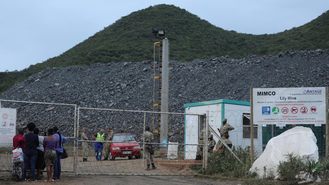 Family members of miners and mine workers stand outside the Goldfields Lilly Mine in Barberton in the South African Mpumalanga province after a gold mine collapsed on February 5, 2016. (AFP)