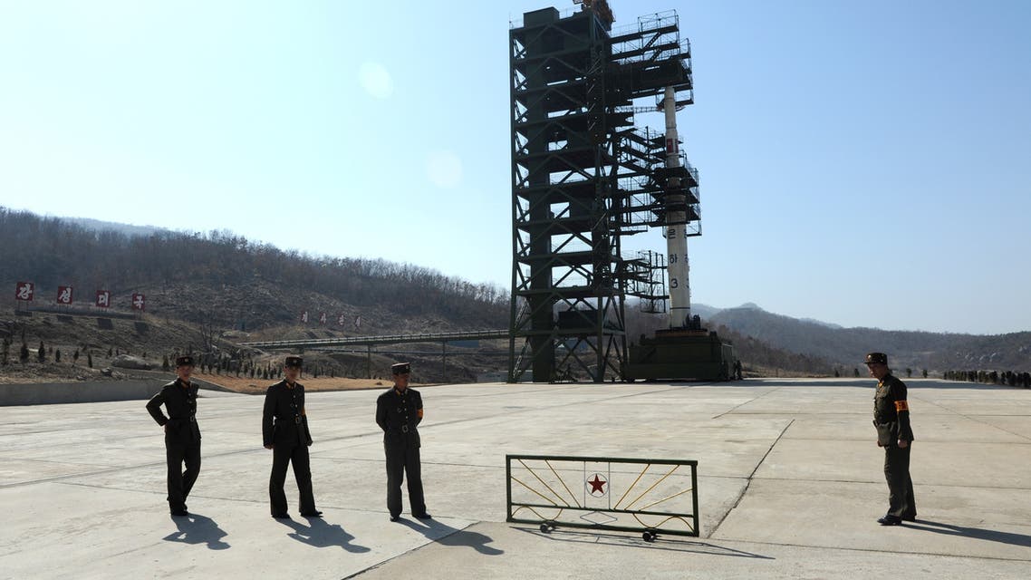 North Korean soldiers stand guard in front of the Unha-3 rocket at the Sohae Satellite Launch Station in Tongchang-Ri on April 8, 2012. North Korea has confirmed their intention to launch the rocket next week despite international condemnations. AFP PHOTO/ Pedro UGARTE