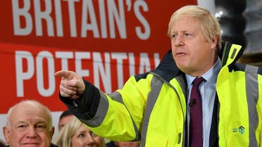 Britain's Prime Minister and Conservative leader Boris Johnson (R) talks during a question and answer session on a general election campaign visit to Fergusons Transport in the town of Washington, west of Sunderland, northeast England, on December 9, 2019. (AFP)