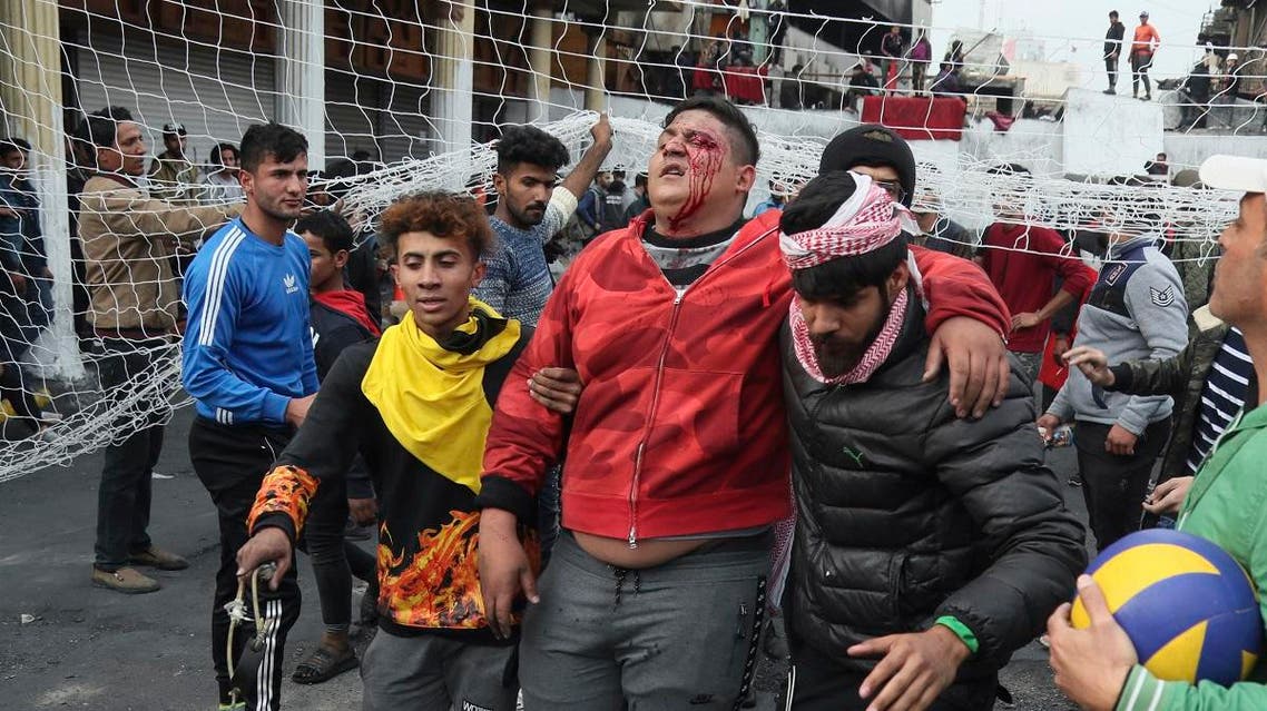 Protesters evacuate an injured protester during minor clashes with Iraqi riot police at a bridge in Baghdad, Iraq, Tuesday, Dec. 10, 2019. (AP)