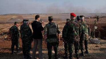 Assad visits troops in Syria Idlib October 22, handout by SANA, Reuters