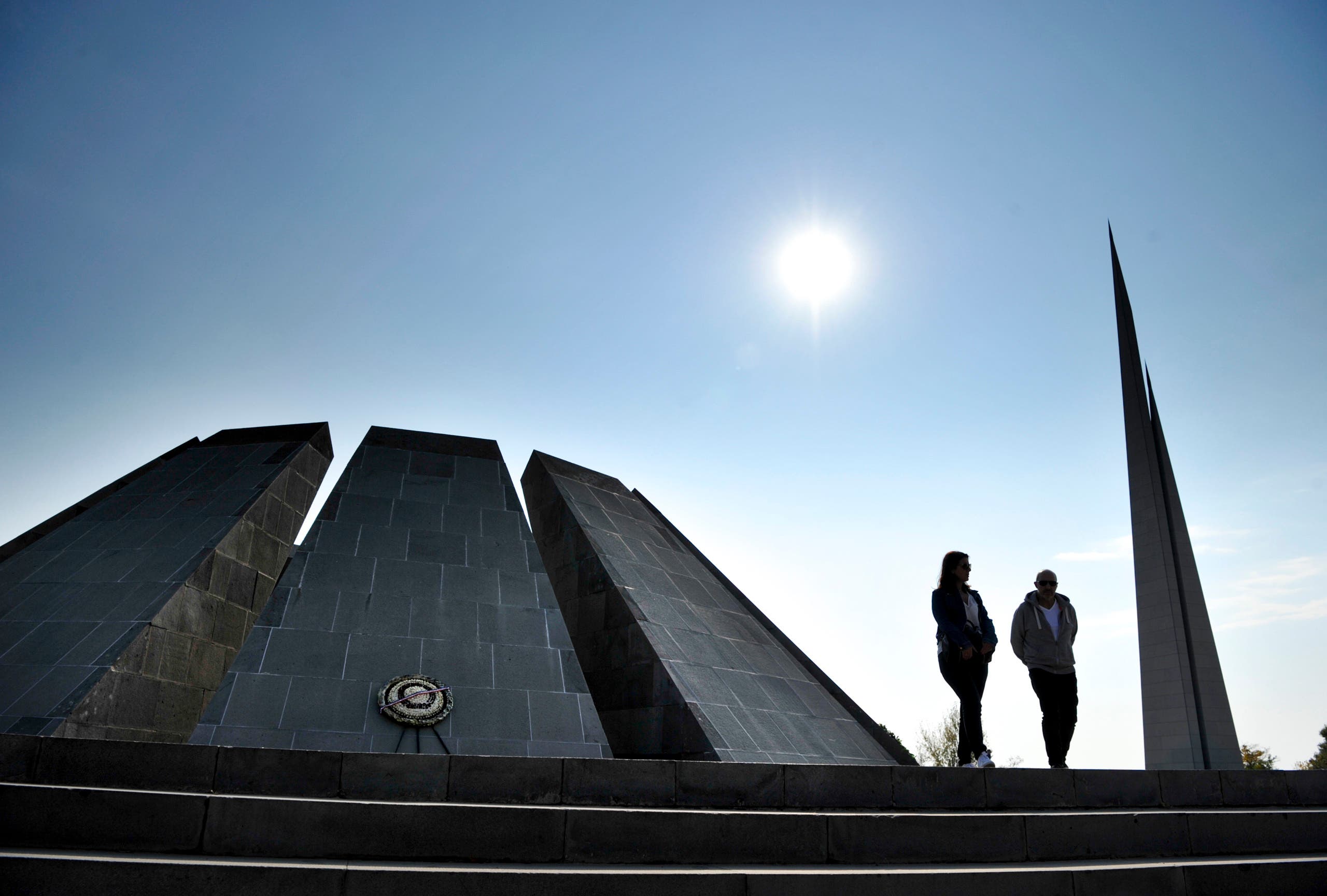 A couple walk at the Tzitzernakaberd memorial to the victims of genocide by Ottoman Turks, in the Armenian capital Yerevan, Armenia on Oct. 30, 2019. (AP)