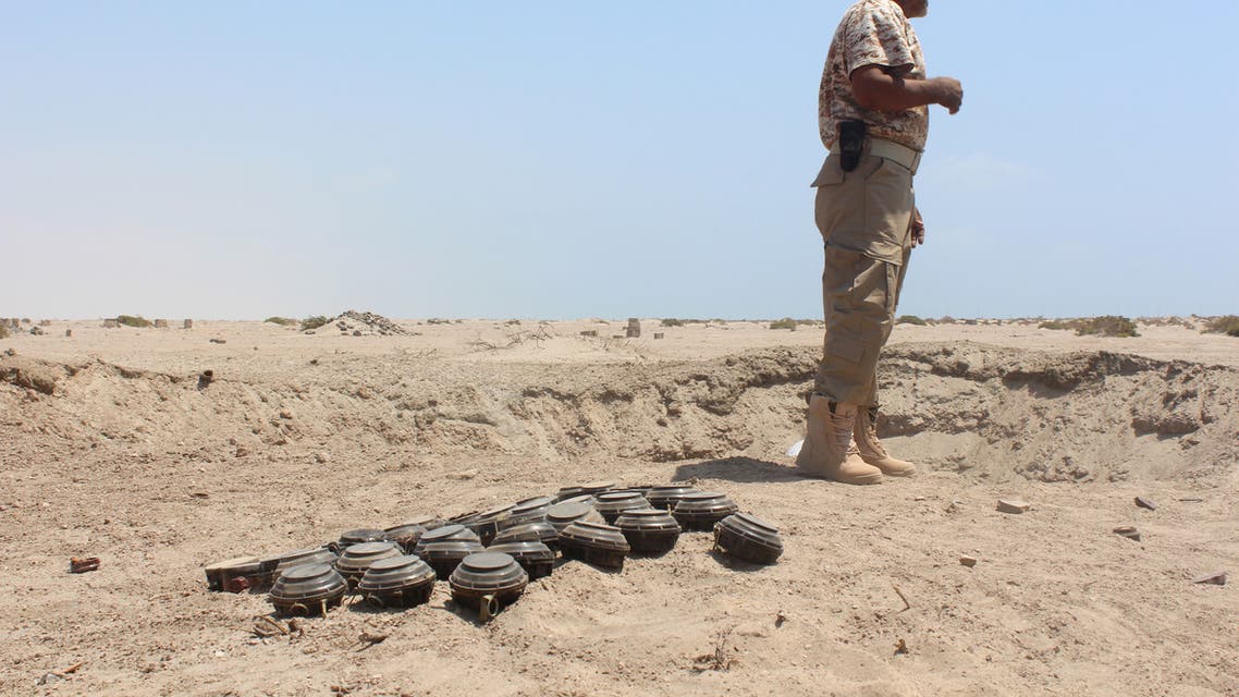 A Yemeni security forces member stands next to unexploded ordnance confiscated from the Shiite Huthi rebels and militant extremists, as he prepares to neutralise the mines and explosives in the desert of al-Alam, east of the southern port city of Aden, on March 10, 2016. Al-Qaeda in the Arabian Peninsula, the jihadist network's powerful Yemeni affiliate, has taken control of some parts of the country and a local branch of the Islamic State (IS) group has also emerged as a new threat. Al-Qaeda and IS jihadists have stepped up attacks in Aden despite the efforts of the government and its backers in a Saudi-led coalition battling the Huthis and their allies to secure it.