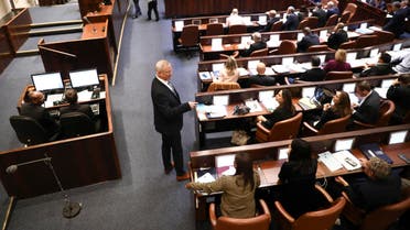 Blue and White party leader Benny Gantz, center, stands during a Knesset session in Jerusalem, Wednesday, Dec. 11, 2019. (AP)