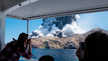 Tourists on a boat look at the eruption of the volcano on White Island, New Zealand. (Photo: AP)