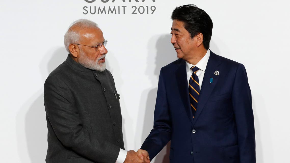 India's Prime Minister Narendra Modi, left, is welcomed by Japanese Prime Minister Shinzo Abe upon his arrival for an welcome and family photo session at G-20 leaders summit in Osaka, Japan, Friday, June 28, 2019. (AP)