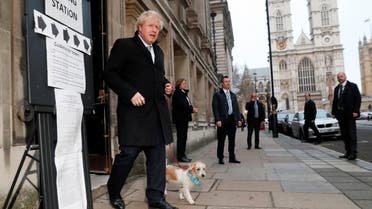 Britain's Prime Minister Boris Johnson leaves with dog Dilyn at a polling station, at the Methodist Central Hall, after voting in the general election in London. (Reuters)
