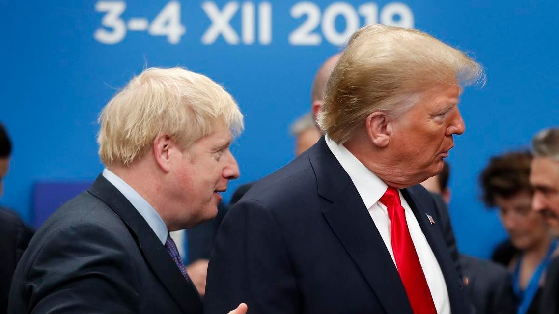 British Prime Minister Boris Johnson walks over to U.S. President Donald Trump who is talking to Canadian Prime Minister Justin Trudeau prior to a NATO leaders meeting. (AP)