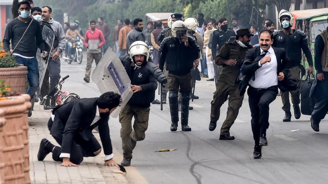 Policemen chase lawyers following a clash between lawyers and doctors in Lahore on December 11, 2019. (AFP)