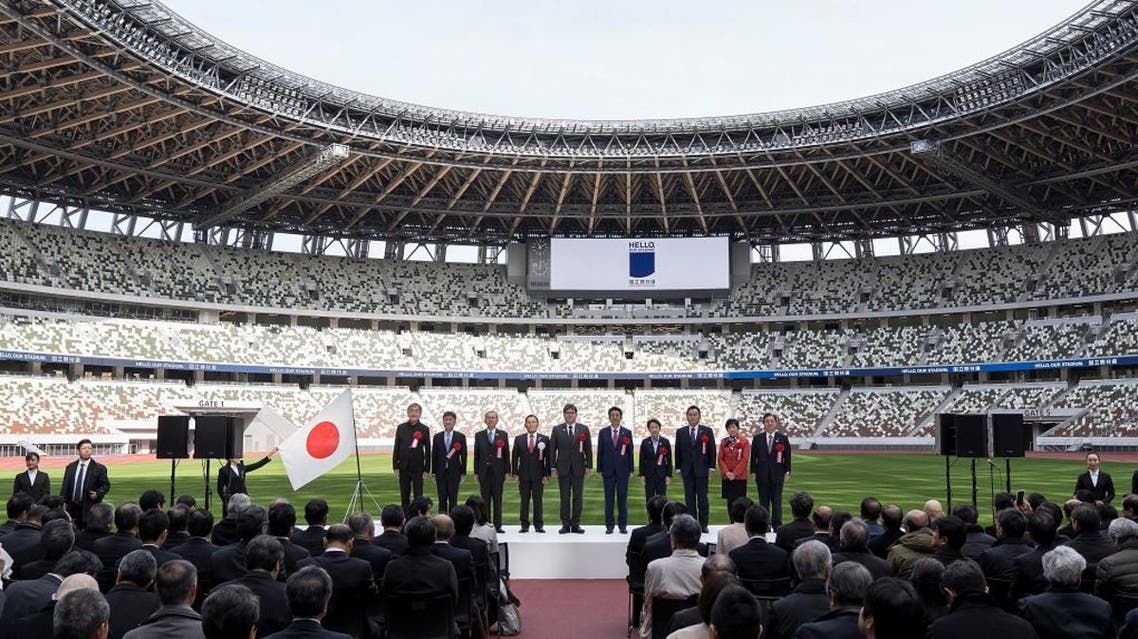 People pose during a group photograph during the construction completion ceremony of the New National Stadium on December 15, 2019 in Tokyo, Japan. (Photo: Reuters)