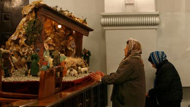 Iranian Christian women pray during a Christmas Eve mass at the St. Grigor Armenian Catholic church in Tehran, Iran, Wednesday, Dec. 24, 2008. (AP)