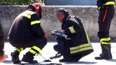 Italian firefighters inspect the site where an explosive device blasted outside "Francesca Morvillo Falcone" high school in Brindisi, Italy, Saturday, May 19, 2012 (AP)