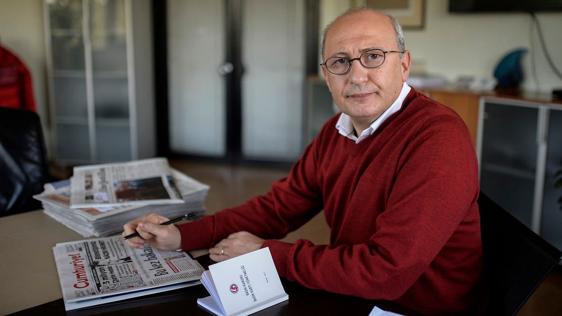 The editor-in-chief of the Turkish daily Cumhuriyet Utku Cakirozer (R) speaks to a staff member in his office on January 14, 2015 in istanbul. Cumhuriyet on January 14 printed excerpts from the first issue of the French satirical weekly Charlie Hebdo since Islamist gunmen killed 12 people in Paris on January 7 in an attack on its offices, defying a growing outcry in the Islamic world over the edition. Cumhuriyet, which strongly opposes President Recep Tayyip Erdogan, was the sole publication in a majority Muslim country to reproduce a special section of cartoons and articles from the Charlie Hebdo issue. AFP PHOTO / BULENT KILIC