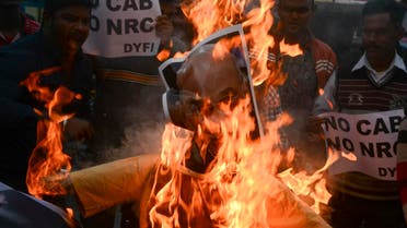 Indian left wing activists of Democratic Youth Federation of India (DYFI) shout slogans as they burn an effigy of India's Home Minister Amit Shah during a demonstration against the Indian government's Citizenship Amendment Bill in Siliguri. (AFP)
