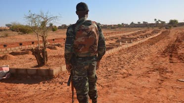 A Niger soldier looks at the graves of the soldiers killed before the arrival of the Leaders of the G5 Sahel nations in Niamey, on December 15, 2019. (AFP)