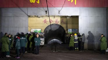 Rescuers and staff members wait outside the site of a coal mine explosion in Pingyao, in China's northern Shanxi province early on November 19, 2019. (AFP)