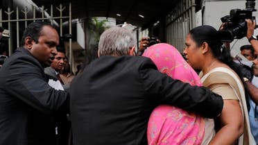 Sri Lankan Swiss embassy worker Gania Banister Francis, covered in pink shawl, is escorted by police to her a magistrate court after her arrest in Colombo, Sri Lanka. (Photo: AP)