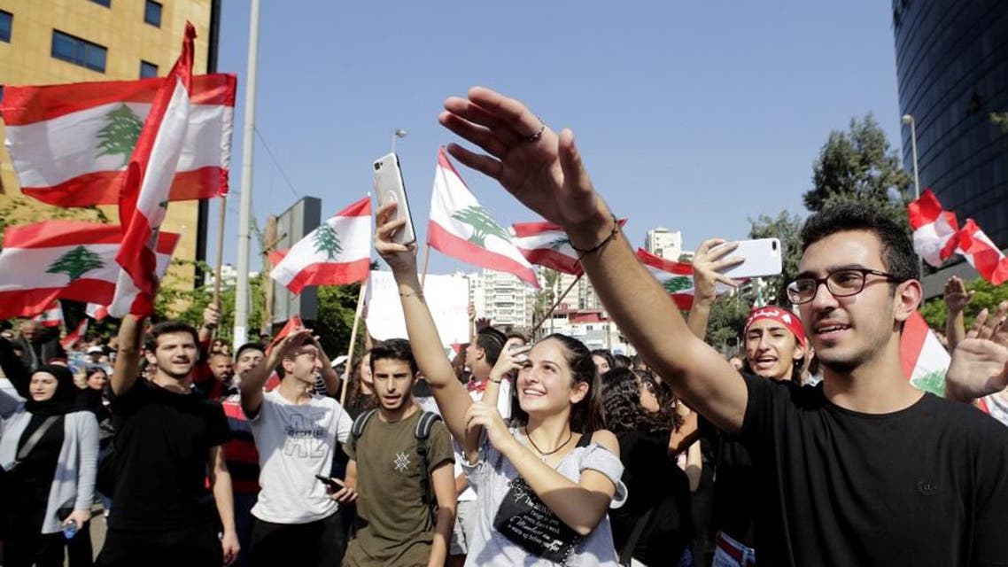 Lebanese students from various schools wave national flags and shout slogans as they gather in front of the Ministry of Education. (File photo: AFP)