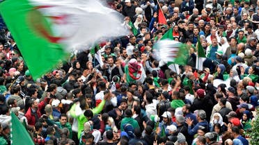 Algerian protesters wave national flags during an anti-government demonstration in the capital Algiers, on December 20, 2019. (AFP)