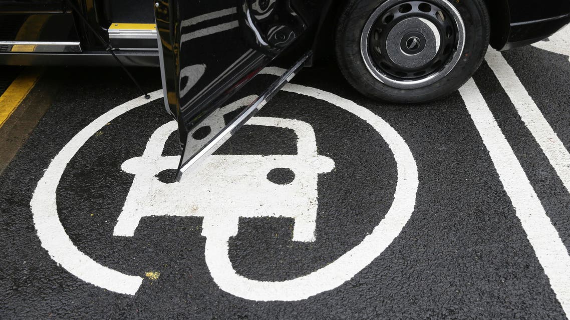 The electric car recharging sign, as a new TX Cab London taxi is parked at a charging station during a media opportunity at a Shell petrol station on Holloway road, in London, Wednesday Oct. 18, 2017, 2017. (AP)