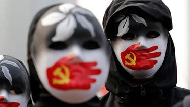 People wearing masks stand during a rally to show support for Uighurs and their fight for human rights in Hong Kong, Dec. 22, 2019. (Photo: AP)