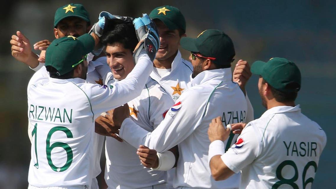 Pakistani players greet Naseem Shah after the dismissal of Sri Lankan batsman during the second Test in Karachi, Pakistan, Sunday, Dec. 22, 2019. Pakistan continued to take the second test away from Sri Lanka with yet another record-making day, reaching 555-3 at lunch on the fourth day and pushing their lead to 475 runs. (AP Photo/Fareed Khan)