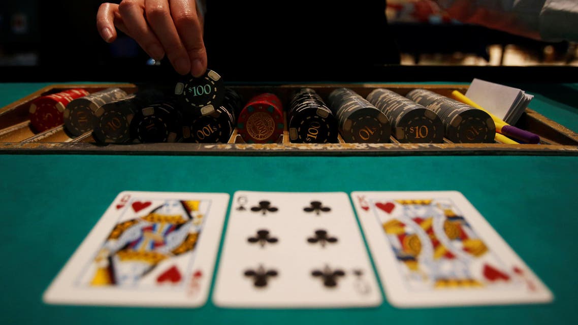 A dealer picks up chips on a mock black jack casino table during a photo opportunity at an international tourism promotion symposium in Tokyo, Japan September 28, 2013. REUTERS/Yuya Shino/File Photo