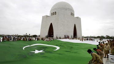 Students hold a giant representation of a Pakistani flag at the mausoleum of Muhammad Ali Jinnah, founder of Pakistan in Karachi, Pakistan. (AP) 