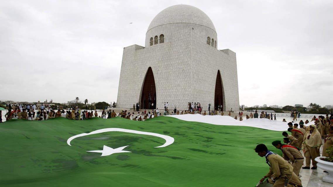 Students hold a giant representation of a Pakistani flag at the mausoleum of Muhammad Ali Jinnah, founder of Pakistan in Karachi, Pakistan. (AP)