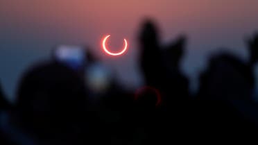 People take photos with their smartphones as they monitor the annular solar eclipse on Jabal Arba (Four Mountains) in Hofuf, in the Eastern Province of Saudi Arabia, December 26, 2019. REUTERS/Hamad I Mohammed