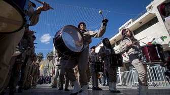 Palestinians in Bethlehem spread Christmas cheer with tradition, music, prayer