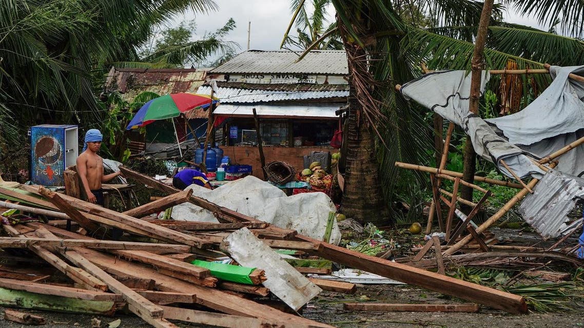 A resident looks at a house damaged at the height of Typhoon Phanfone in Tacloban, Leyte province in the central Philippines on December 25, 2019. (AFP)