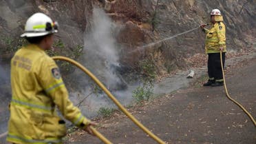 Firefighters keep an eye on the slow-moving fire near Mangrove Mountain, north of Sydney, Tuesday, Dec. 10, 2019. (Photo: AP)